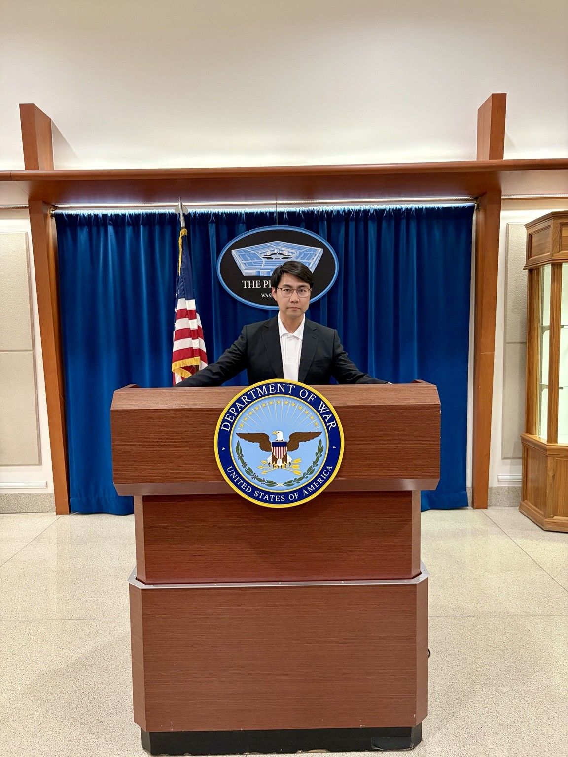Ji Hoon Park standing at a podium during a visit in Washington, D.C.